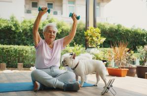 Woman working out outside with her dog.