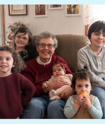 Carole holding her grandchildren
