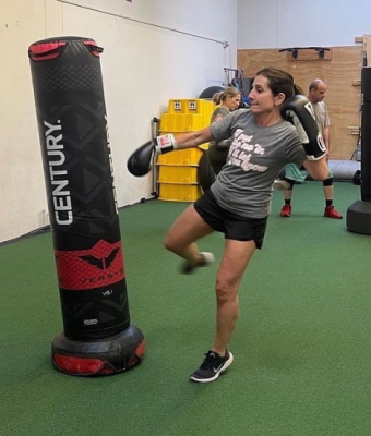 Woman in a gym boxing.