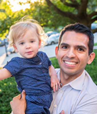 Joel Diaz holding his daughter