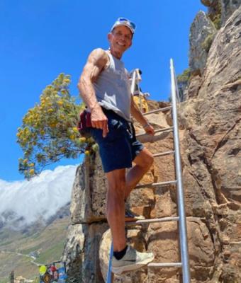 Kim on a ladder on a mountain