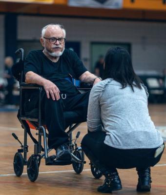 Man in wheelchair at Rock Steady Boxing class