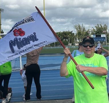 Dale Picciano waving a flag at a Moving Day event