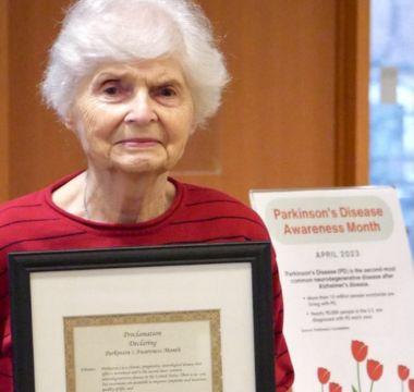 Barbara Traynor holding a Parkinson's Awareness Month proclamation