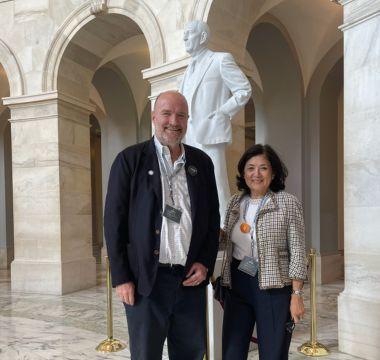 Derek Bonnie Bandeen posing by a statue