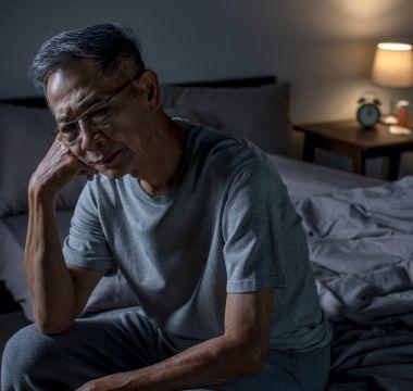 Man sitting in bed cannot sleep