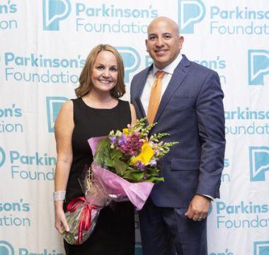 Ann receiving flowers at PF event