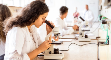 Scientist looking at microscope