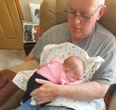 Christine's dad holding a baby