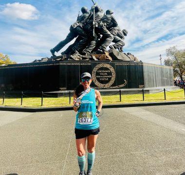 Christine Shearman holding up medal at Parkinson's Champions race