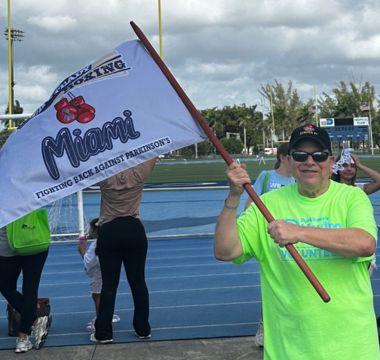 Dale Picciano waving a flag at a Moving Day event