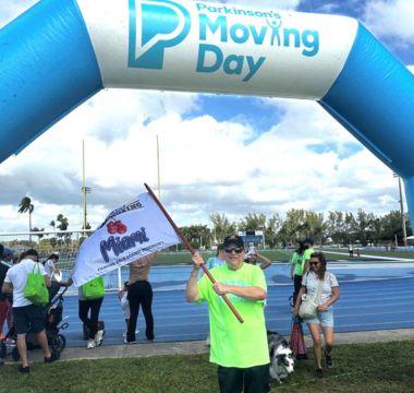 Dale Picciano waving a flag at a Moving Day event