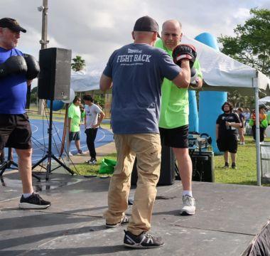 Dale practices boxing with a trainer at an event