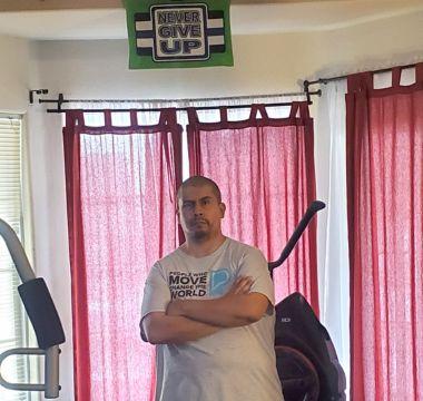 Ian standing by an exercise machine