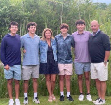 Jen and Rock posing for a picture outside with their sons