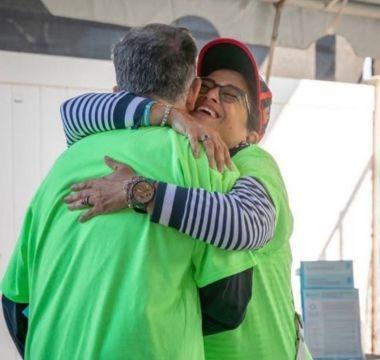John hugging another Moving Day volunteer