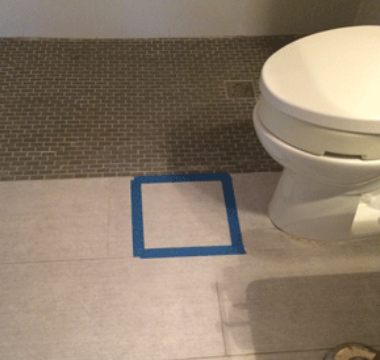 blue tape by a toilet