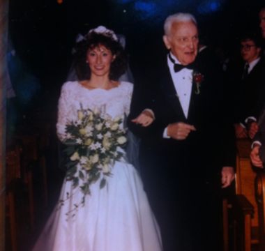 Mary Ann walking down the aisle with her dad at her wedding