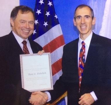 Photo of Paul Rohrlich posing with certificate