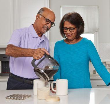 Radhika and Dharma making coffee in their kitchen
