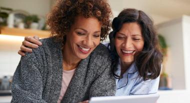 2 women looking at ipad