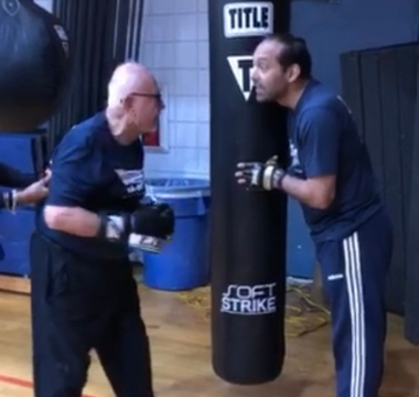 Man with punching bag at Rock Steady Boxing class