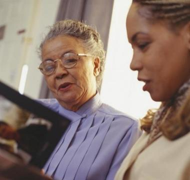 Older woman and younger woman looking at photos