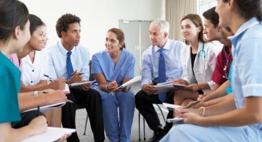 Group of medical professionals sitting in a circle