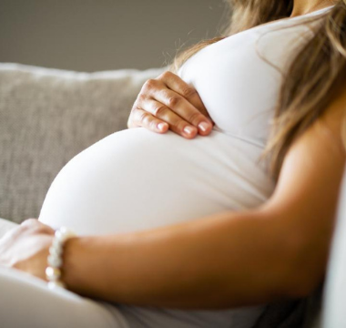 Pregnant women holding her belly