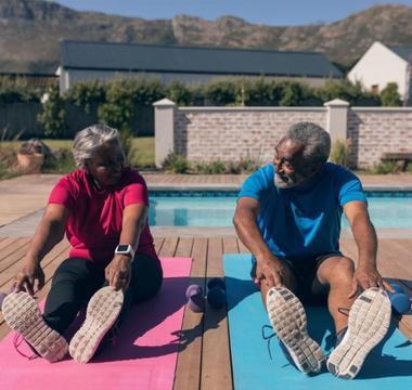 man and woman stretching on yoga mats