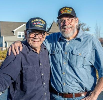 Two veterans with their arms around each other