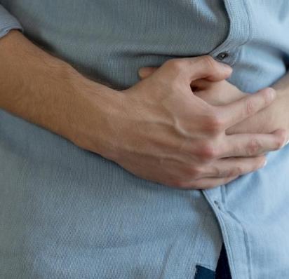 Man holding stomach in pain