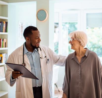 Male doctor with female patient, patting her back