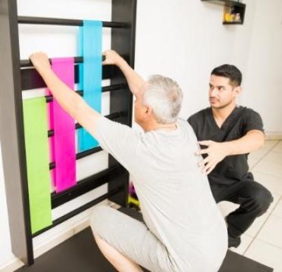 Physical therapist helping patient exercise