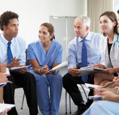 Group of medical professionals sitting in a circle
