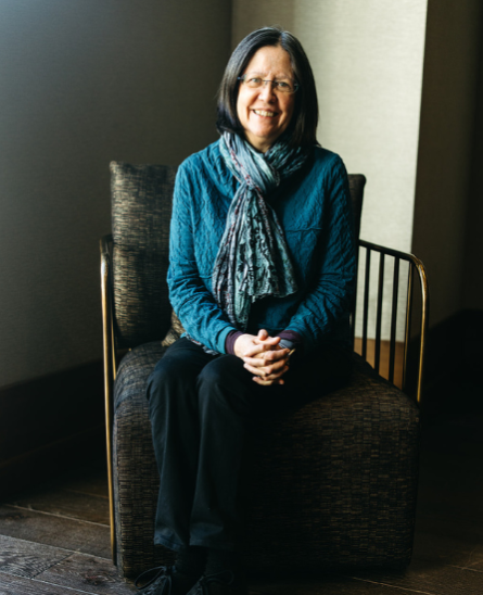 Kathy Blake sitting on a chair posing for a picture