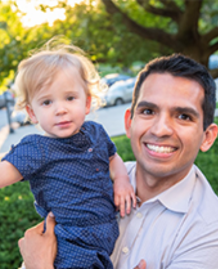 Joel Diaz holding his daughter