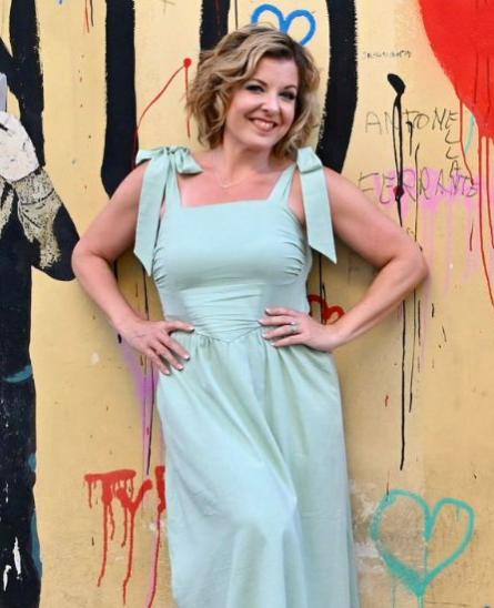 Tamara posing for a picture in a blue dress
