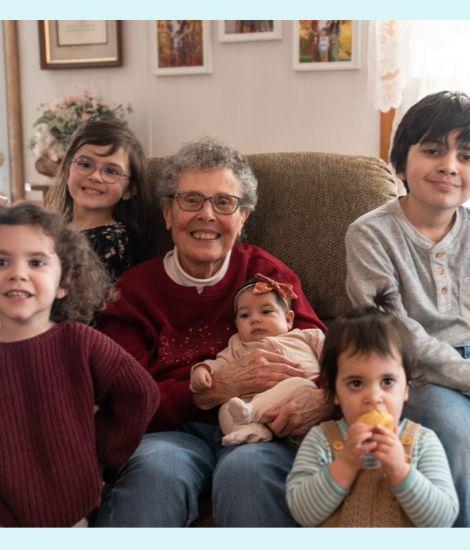 Carole holding her grandchildren