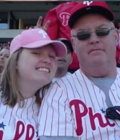 Christine and her dad at a baseball game