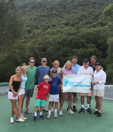 Dick Field and family holding PF banner