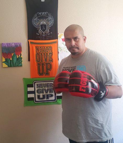 Ian Rodriguez posing with boxing gloves on