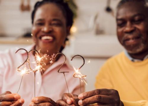 Husband and wife holding 2022 sparklers