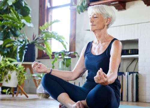 Woman meditating in her livingroom