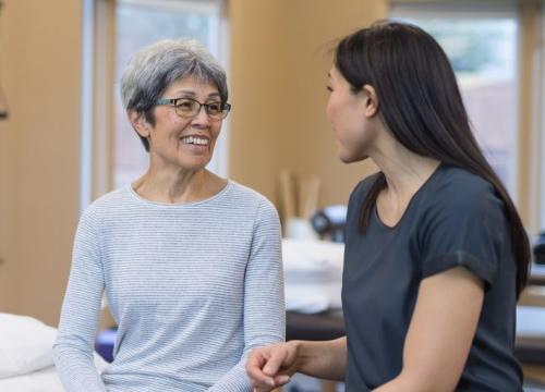 Physical therapist talking with her patient
