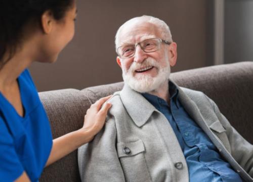 Nurse resting her hand on the shoulder of her patient