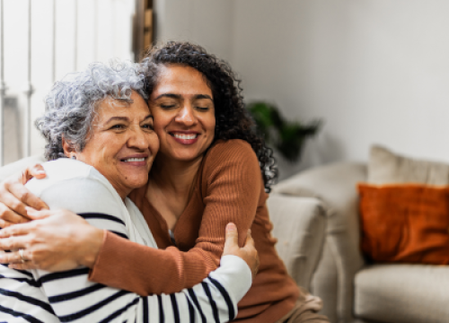 An older and younger women hugging