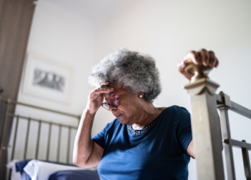 Older woman hunched over in pain