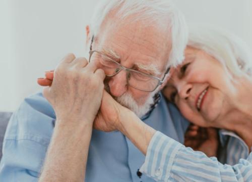 Man kissing his wife's hand