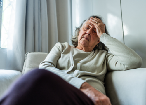 Women sitting on couch in pain